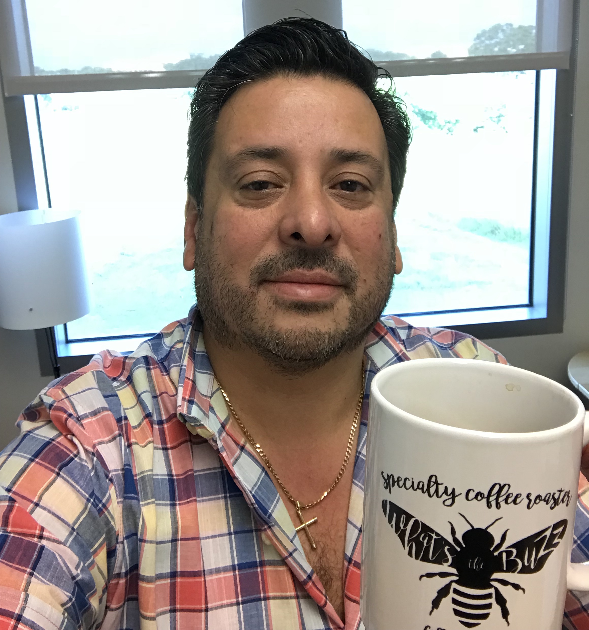 Rodrigo holding coffee cup