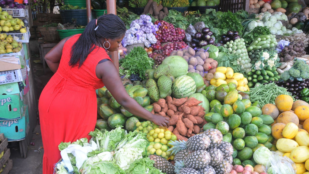 A woman inspects vegetables for sale in Accra, Ghana. Photo: Felix Antonio/IWMI.